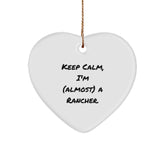 Funny Rancher Gifts from Friends - Keep Calm, I'm (almost) A Rancher. Heart Ornament for Christmas - Image 1